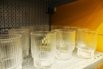transparent glasses on the store shelf. Glassware
