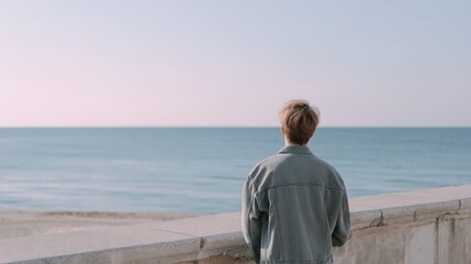 Fototapeta premium emotional seaside memory in Madrid, soft pastel tones, person looking at distant ocean, faded summer light, minimalistic and quiet