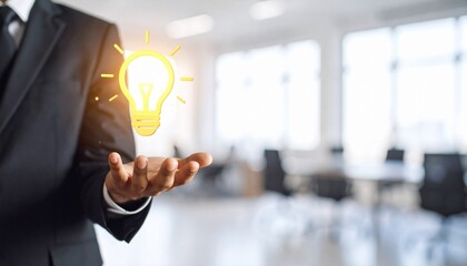 3D scene with a lightbulb-shaped idea icon floating above the hand of a blurred man in a suit
