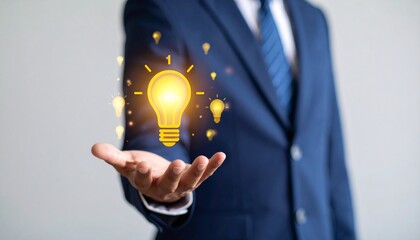 3D scene with a lightbulb-shaped idea icon floating above the hand of a blurred man in a suit