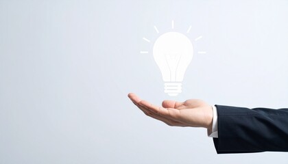 3D scene with a lightbulb-shaped idea icon floating above the hand of a blurred man in a suit