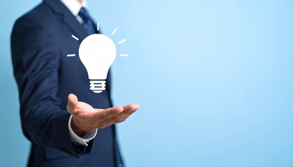 3D scene with a lightbulb-shaped idea icon floating above the hand of a blurred man in a suit