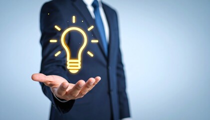 3D scene with a lightbulb-shaped idea icon floating above the hand of a blurred man in a suit
