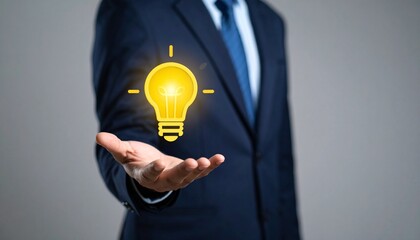 3D scene with a lightbulb-shaped idea icon floating above the hand of a blurred man in a suit