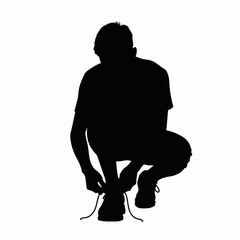 Student tying shoelaces, adjusting his footwear before a run. Student tying shoelaces on a white background showcases a moment of preparation and focus, hinting at fitness and readiness.
