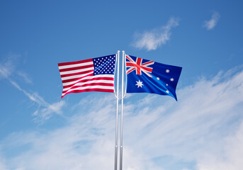 flags of  australia and United States of America over blue sky background.
