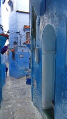 Arched doorway by an intersection in a narrow alley in the medina in Chefchaouen, Morocco