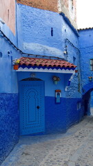 Blue door in a blue wall in the medina in Chefchaouen, Morocco
