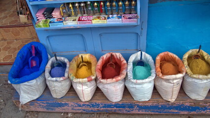 Sacks of colorful, powdered dye on display in front of a shop in the medina in Chefchaouen, Morocco