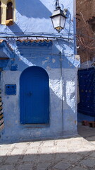 Blue door in a blue wall in the medina in Chefchaouen, Morocco