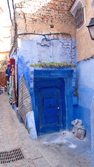 Blue door in a blue wall in the medina in Chefchaouen, Morocco