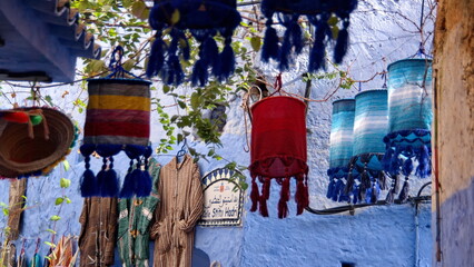 Colorful cloth lanterns hanging above an alley in the medina in Chefchaouen, Morocco