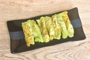 soft fresh coconut crepe topping black sesame Thai sweetmeat arranging on plate