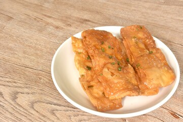 fried crispy sweet southern flat bread or roti dressing sweetened condensed milk on dish