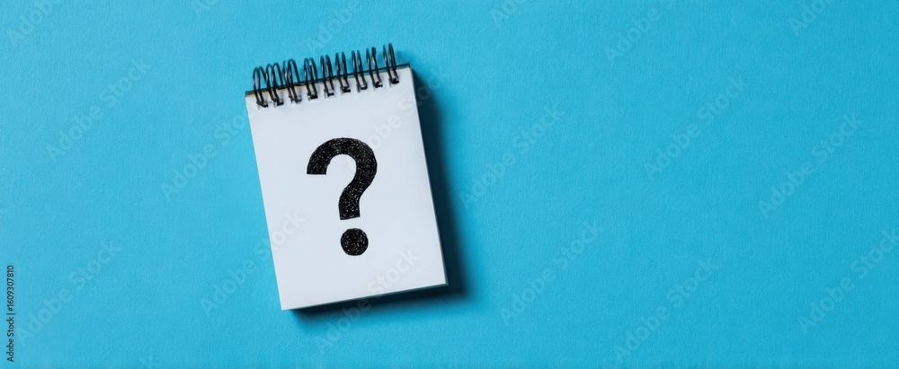 Poster the notebook with a question mark representing curiosity and exploration of ideas.