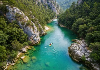 An aerial view of a vibrant blue-green river winding through a dense, lush green forest with rocky cliffs.