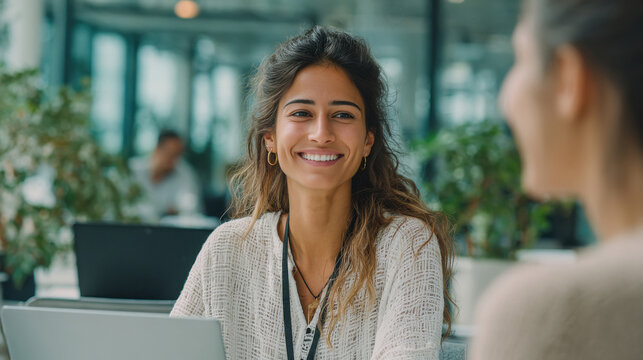 young indian business woman sitting at office working on laptop