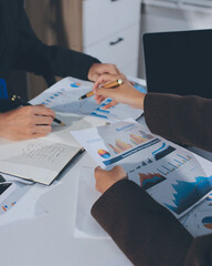 Focused young businessman signing agreement with skilled lawyer in eyeglasses. Concentrated...