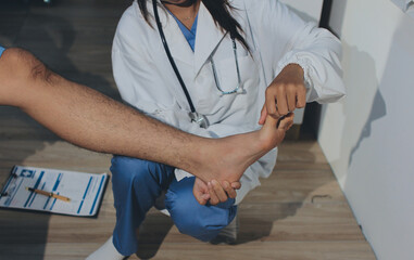 Physical therapist teaching a patient how to do exercises for his knee pain