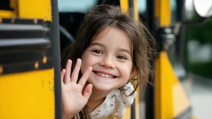 Smiling Girl Waving from Yellow School Bus Window, Expressing Joy and Excitement