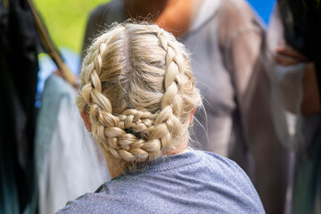 French Braid Hairstyle on Woman. Portrait of the back of a young girl wearing French braids in her hair. French braid close up. 