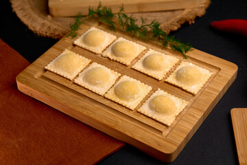 Deliciously Crafted Ravioli on a Wooden Board with Fresh Ingredients and a Touch of Glamour Capturing the Essence of Culinary Artistry
