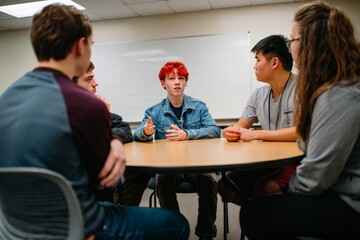 Diverse Group of Young Adults Engaged in Discussion Around Table