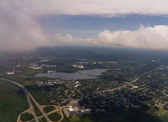 Aerial view of a town with lake and cloudy sky.