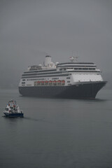 Obraz premium Classic cruiseship cruise ship liner Zaandam arrival into Vancouver, Canada port on grey foggy misty morning from Alaska cruise British Columbia rain day
