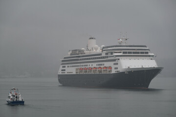 Classic cruiseship cruise ship liner Zaandam arrival into Vancouver, Canada port on grey foggy misty morning from Alaska cruise British Columbia rain day