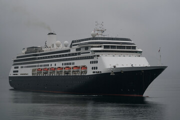 Classic cruiseship cruise ship liner Zaandam arrival into Vancouver, Canada port on grey foggy misty morning from Alaska cruise British Columbia rain day