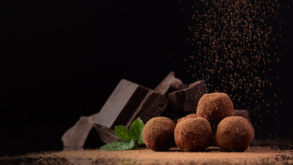chocolate cocoa and various chocolatey dessert with black background 