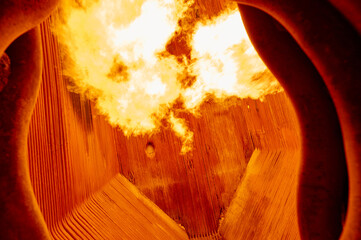 Intense combustion inside a steam boiler furnace at a thermal power plant during operation