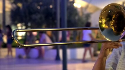 Tight shot of a trombonist's hands and instrument in motion during performance, face out of frame