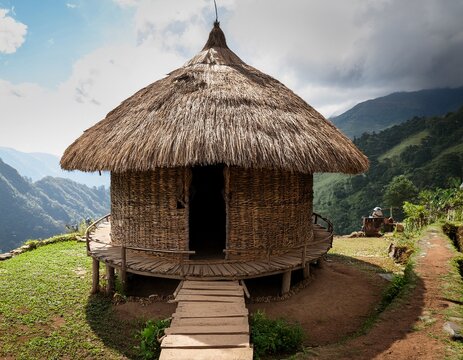 amungme papua mountain house with circular straw thatch roof and wooden base