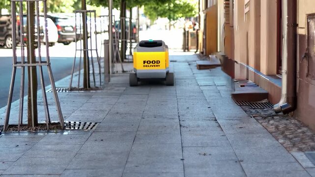 A realistic 3D composite video showing a futuristic food delivery robot driving smoothly along a city sidewalk.