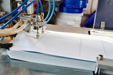 Automatic pneumatic paper sheet feeder in action, facilitating efficient paper handling in a...