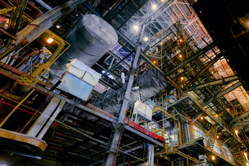 Industrial factory interior with machinery and workers during daytime operations in a large...