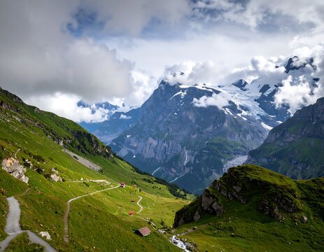Alpine valley with winding paths, red cabins, and snow-capped peaks. Lush green meadows, dramatic mountains, and scattered houses nestled within the valley. Cloudy sky with glimpses of blue - Powered by Adobe
