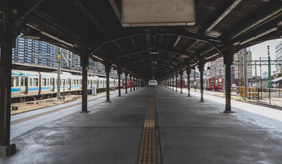 Historic Mojiko Station Platform with Traditional Wooden Architecture and Train in Fukuoka, Japan