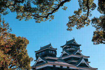 Kumamoto Castle in Japan with Traditional Samurai Architecture on a Clear Blue Sky Day