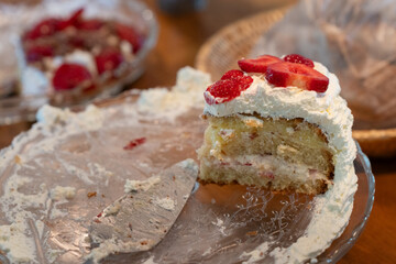 Slice of homemade strawberry cake with chocolate on a birthday party.