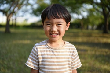 Smiling Asian Boy Outdoors in Summer Sunlight