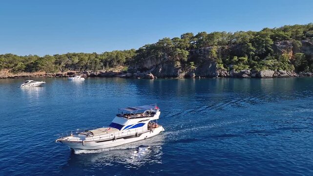 Wonderful Paradise bay of Camyuva, Kemer, Turkey. Scenery sea view to the coast with boats on the blue water. Summertime holiday seascape