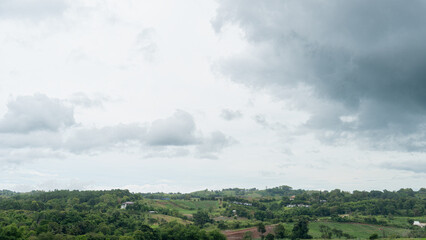 Landscap view of houses are arranged in a perfect harmony between the hills and trees. at Khao Kho Phet Cha Bun Thailand. Under of the sky and clouds.