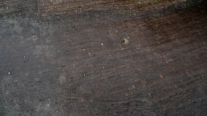 Top view of dark black and brown stone slabs. Different patterns create beauty. Wet surface. For background and textured.