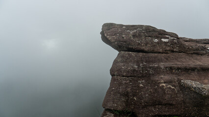 Rocks are layered and have a protruding upper surface that creates a strange effect. Background of...