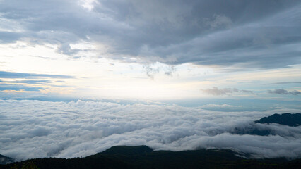 Silhouette forest floor covers the mountain in the morning. Beautiful white fluffy clouds in the distance at Phu Thap Boek, Phetchabun, Thailand.
