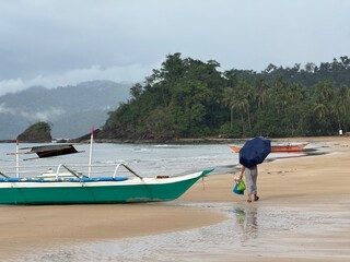 Woman on a Tropical Beach running errands in the rain