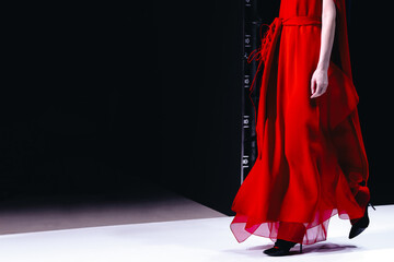 Elegant women fashion, red dress on black background.